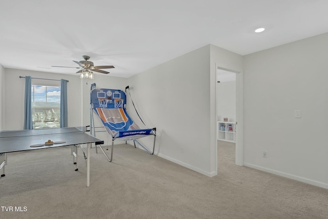 game room with light colored carpet and ceiling fan