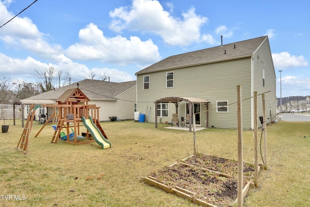 rear view of property featuring a playground, a yard, and a patio area