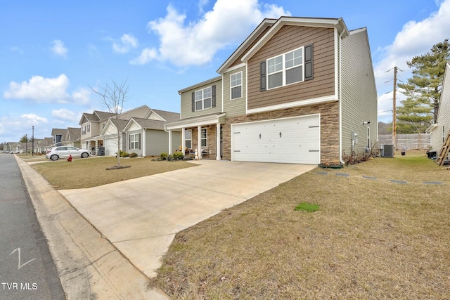 view of front of home with a garage, a front yard, and central air condition unit