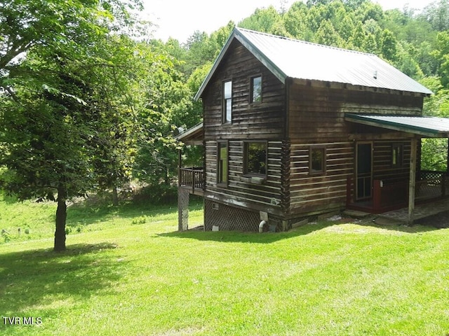 view of side of property with a yard