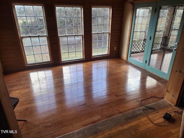 unfurnished dining area featuring a wealth of natural light and wood-type flooring