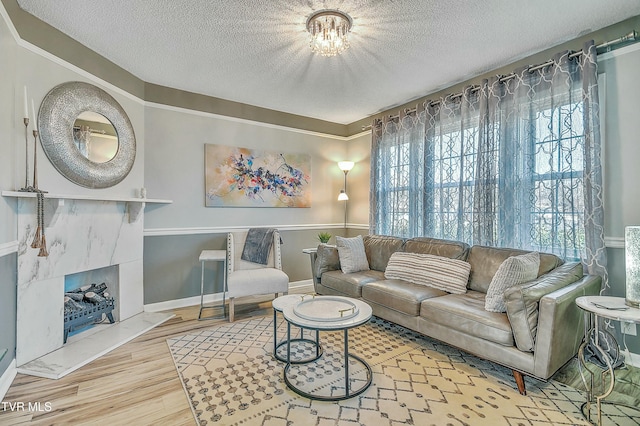 living room featuring hardwood / wood-style flooring, a fireplace, and a textured ceiling