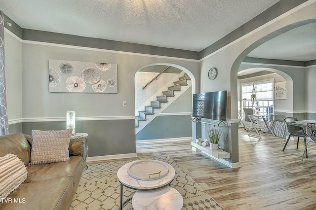 living room featuring hardwood / wood-style flooring and a textured ceiling