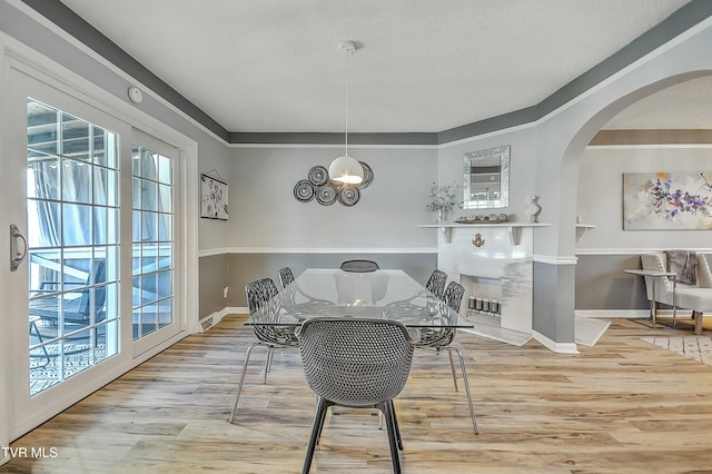 dining area featuring light hardwood / wood-style floors and a textured ceiling