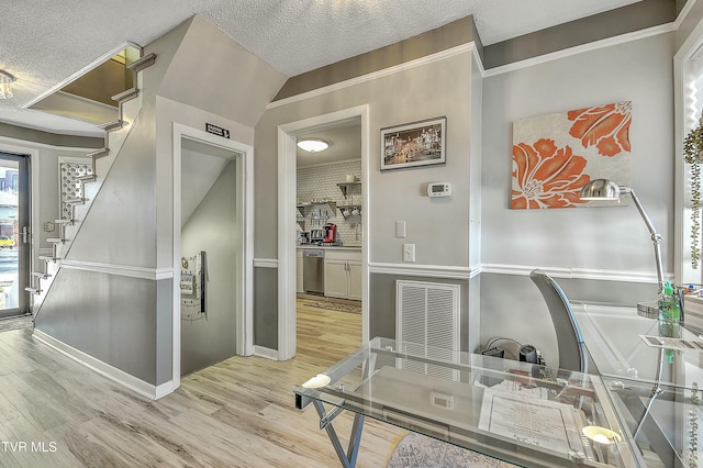 home office featuring a textured ceiling and light wood-type flooring