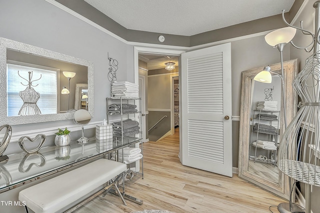 corridor with hardwood / wood-style floors and a textured ceiling