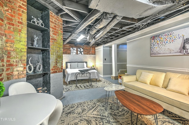 bedroom with concrete floors and brick wall