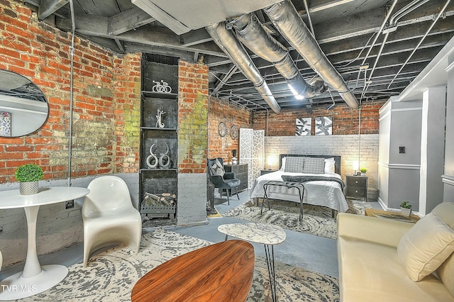 bedroom with brick wall and concrete floors