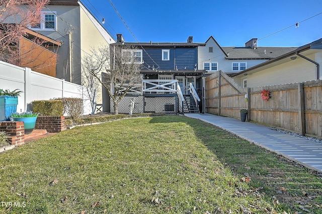 rear view of house featuring a lawn