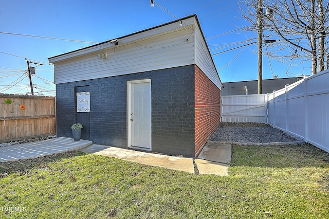 view of outbuilding with a lawn