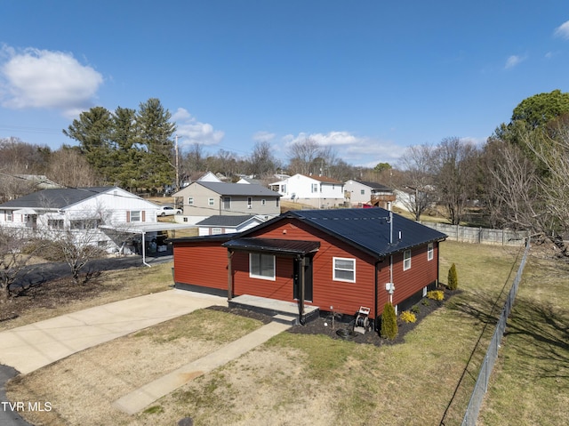 exterior space featuring a front lawn and a carport