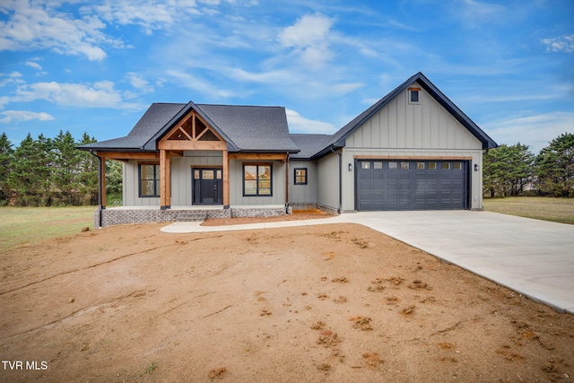 modern farmhouse with a garage and covered porch