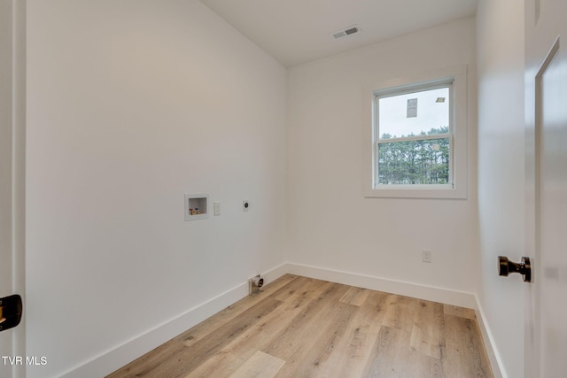 laundry area with hookup for a washing machine, light hardwood / wood-style floors, and hookup for an electric dryer