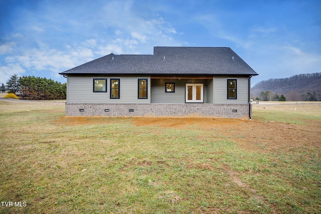 rear view of property with a lawn