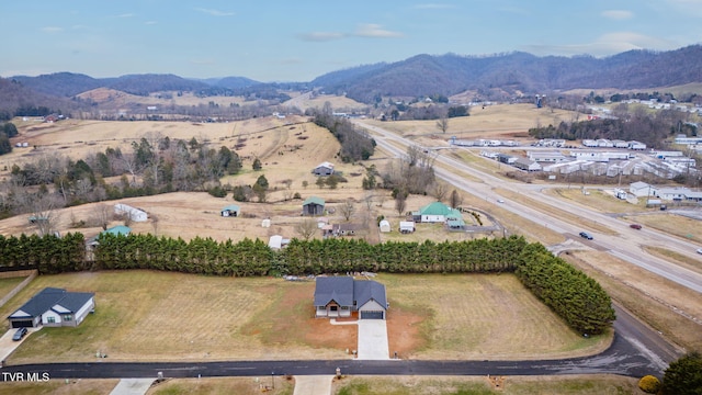 drone / aerial view featuring a mountain view and a rural view