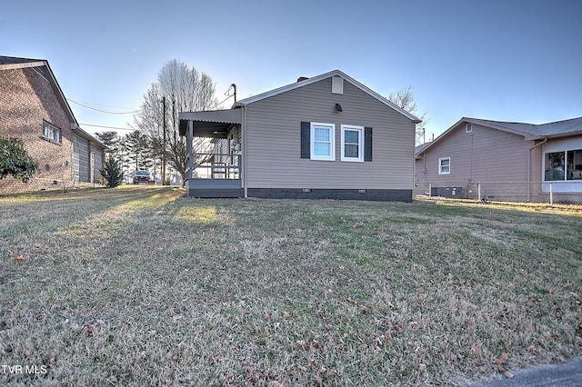 exterior space featuring cooling unit and a front lawn