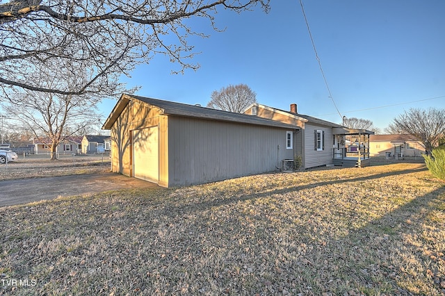 back of property featuring central AC and a lawn