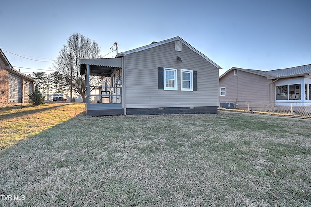 view of side of home with central air condition unit and a lawn