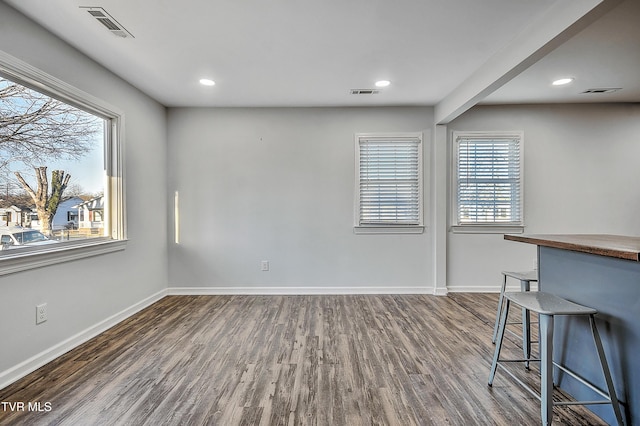 unfurnished dining area featuring dark wood-type flooring