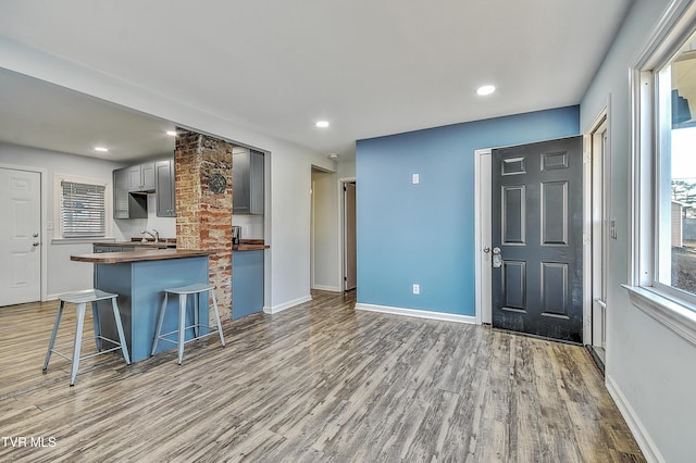 kitchen featuring a wealth of natural light, sink, gray cabinetry, and light wood-type flooring