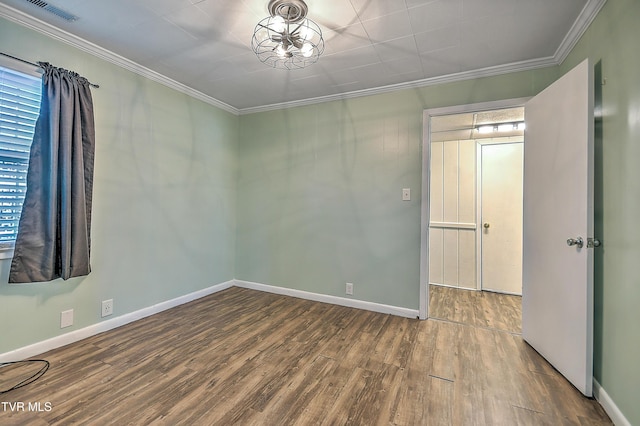 unfurnished room with crown molding and wood-type flooring