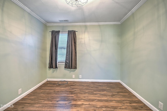 empty room with ornamental molding and dark wood-type flooring