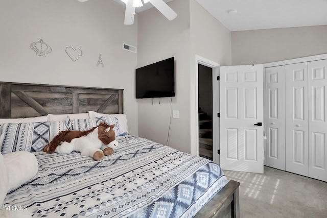 bedroom with lofted ceiling, light colored carpet, a closet, and ceiling fan