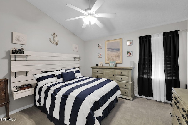 bedroom with ceiling fan, lofted ceiling, and light carpet