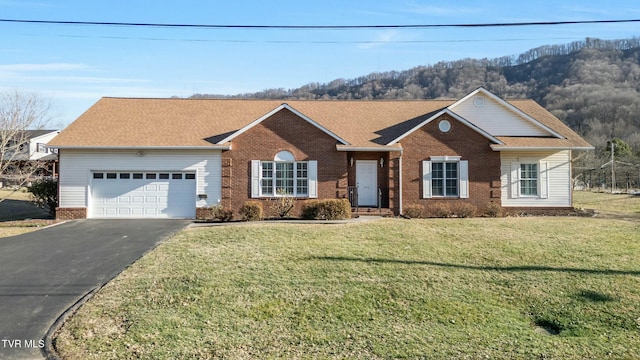 ranch-style home featuring a garage and a front lawn