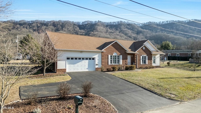 ranch-style house with a garage and a front lawn