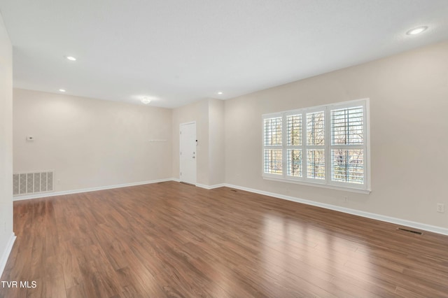 unfurnished room with hardwood / wood-style flooring