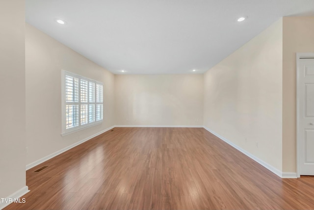 spare room featuring light hardwood / wood-style floors