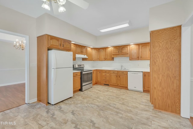 kitchen featuring sink, white appliances, decorative light fixtures, and ceiling fan