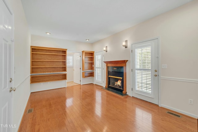 unfurnished living room with wood-type flooring