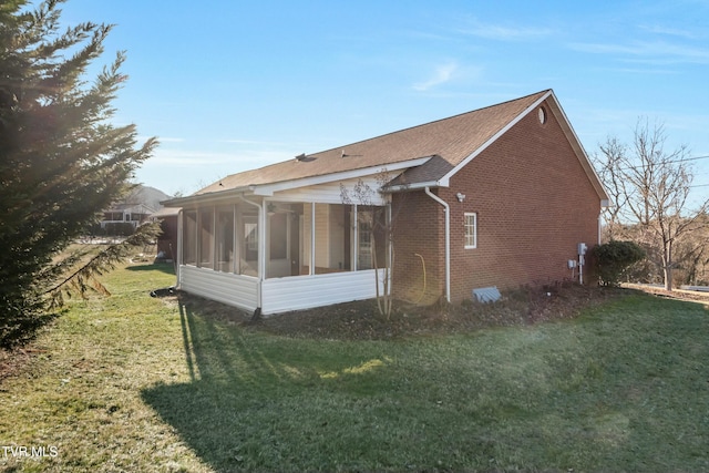 view of property exterior featuring a yard and a sunroom