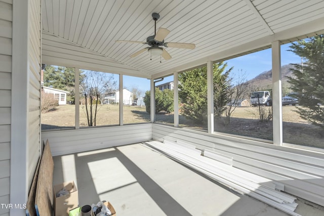 unfurnished sunroom featuring a healthy amount of sunlight and ceiling fan