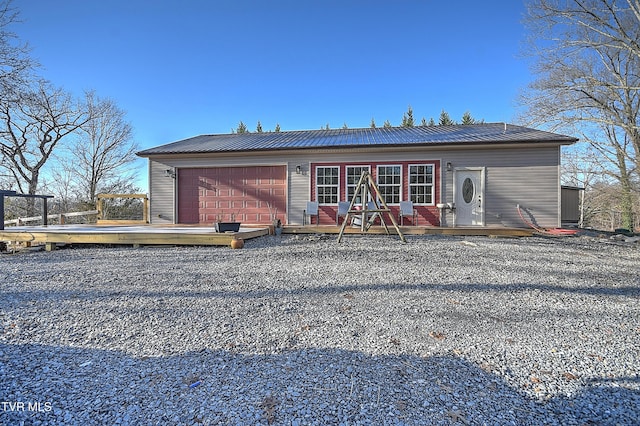 back of property featuring a garage