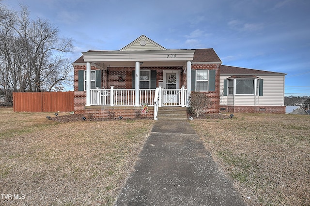 view of front of house with a front yard and a porch