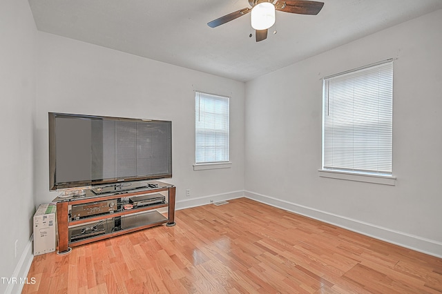 living room featuring ceiling fan and light wood-type flooring