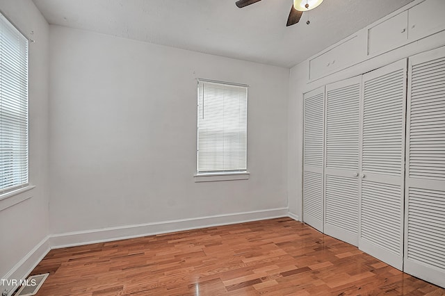 unfurnished bedroom featuring light hardwood / wood-style flooring, a closet, and ceiling fan