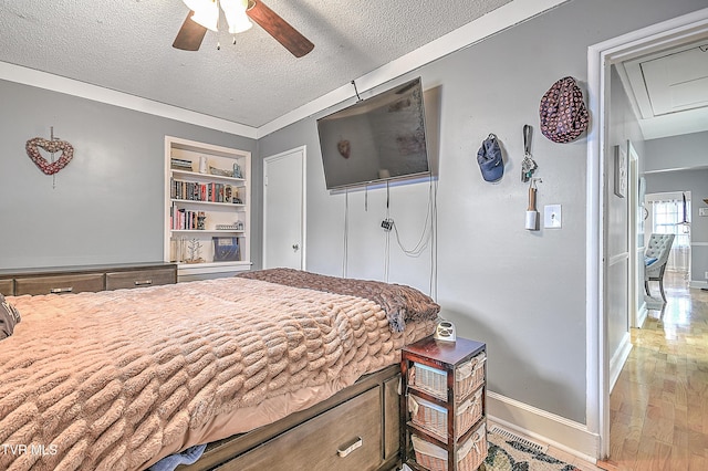 bedroom featuring crown molding, ceiling fan, hardwood / wood-style floors, and a textured ceiling