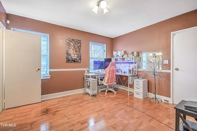 home office with wood-type flooring