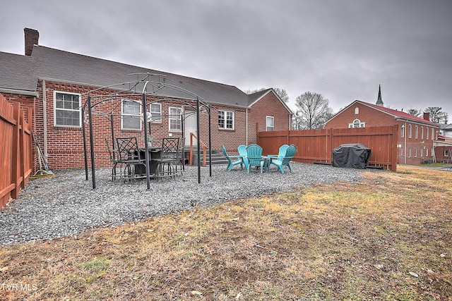 back of house with a lawn