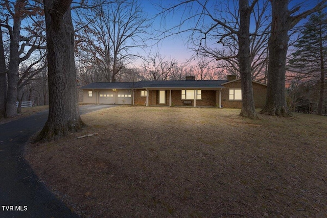 520 Heritage Ln, Jonesborough, TN 37659 - ranch-style home featuring driveway, an attached garage, a chimney, and brick siding