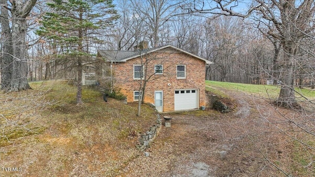 520 Heritage Ln, Jonesborough, TN 37659 - view of property exterior with driveway, an attached garage, a chimney, and brick siding
