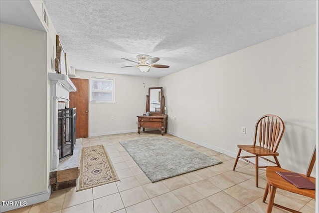 520 Heritage Ln, Jonesborough, TN 37659 - sitting room with a fireplace, light tile patterned floors, ceiling fan, a textured ceiling, and baseboards