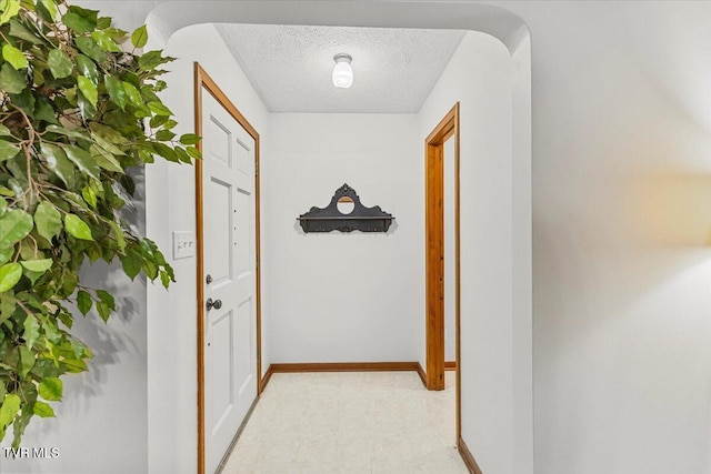 520 Heritage Ln, Jonesborough, TN 37659 - corridor featuring light floors, baseboards, arched walkways, and a textured ceiling