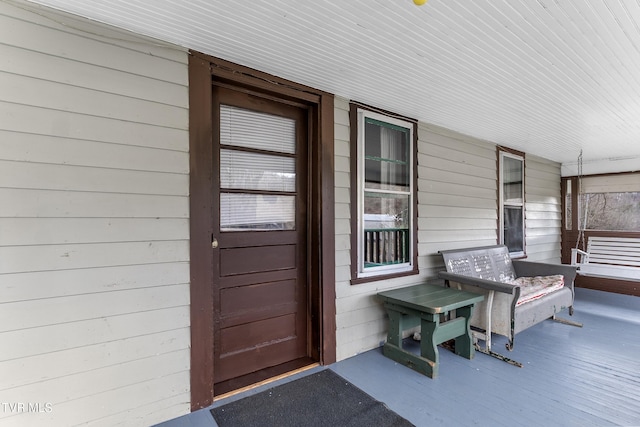 view of exterior entry with covered porch