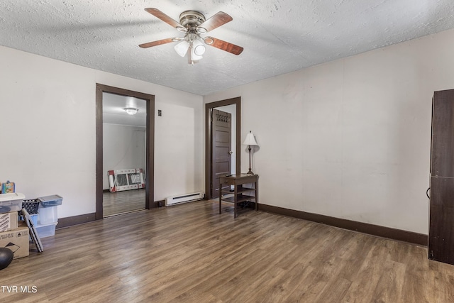 unfurnished room with ceiling fan, dark hardwood / wood-style floors, a textured ceiling, and baseboard heating