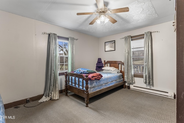 bedroom with multiple windows, carpet flooring, ceiling fan, and baseboard heating